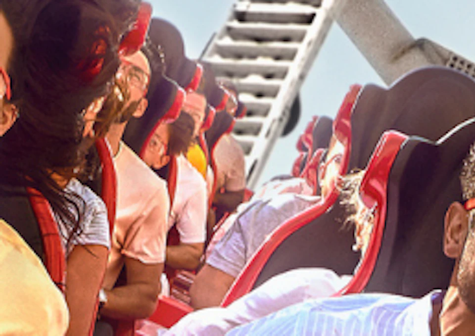 Split image: on the left, a futuristic, dark interior with a circular window; on the right, people on a red rollercoaster outdoors.