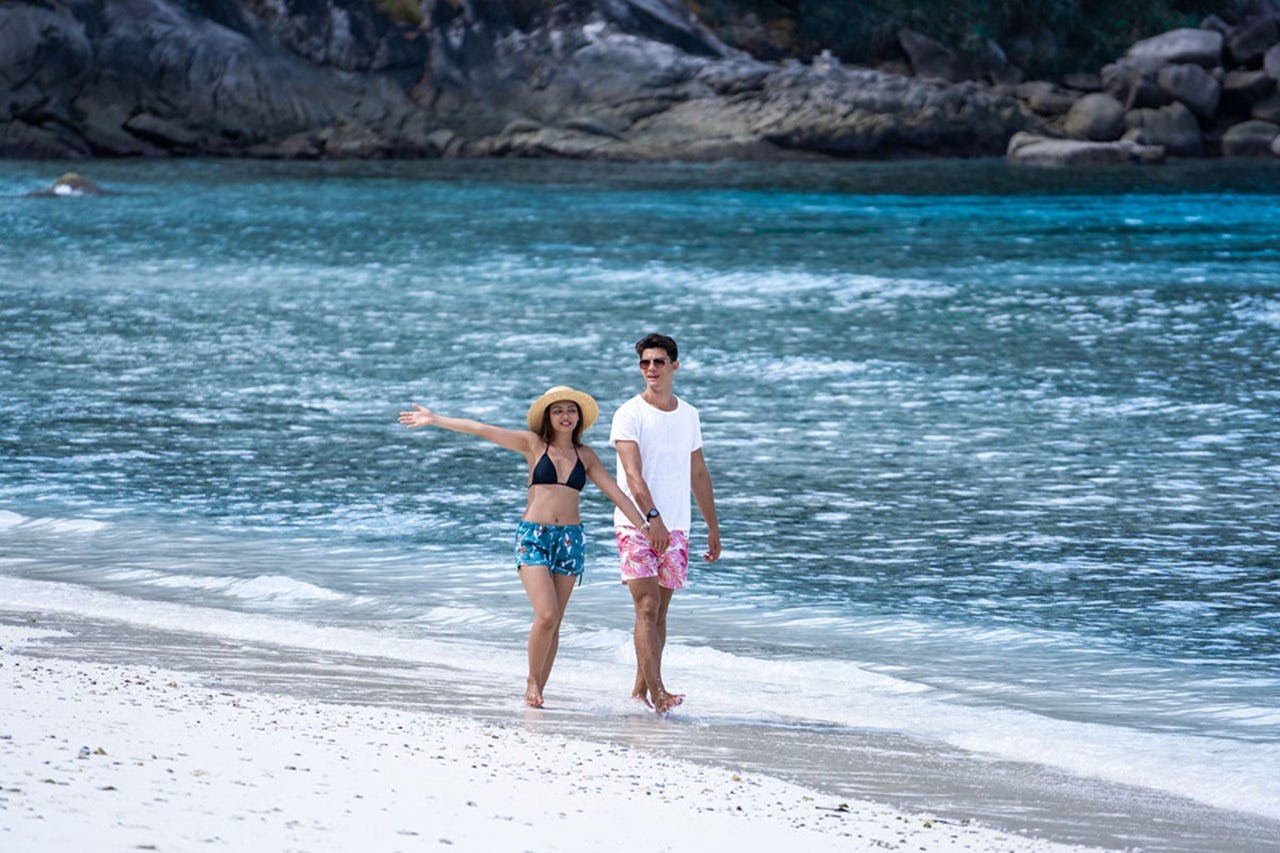 Relax on the sandy shores, soaking up the sun and ocean views.