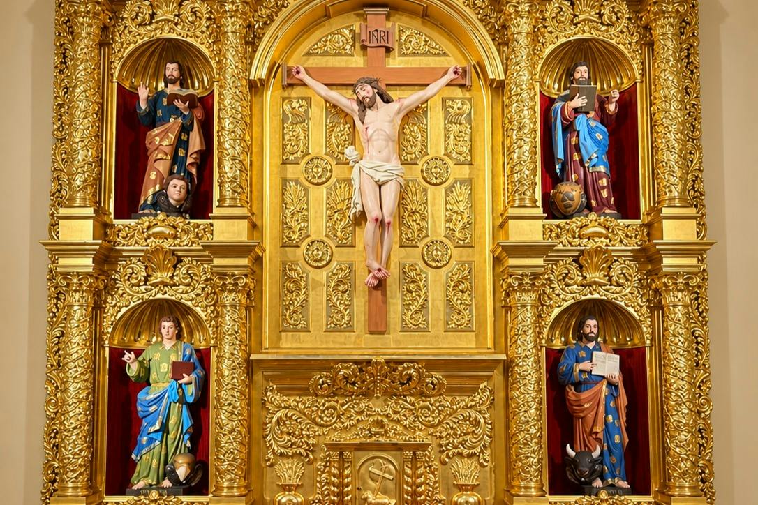 Elaborate golden altar with religious statues, including a crucifix and figures in colorful attire, in a detailed setting.