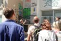 Guide and guests looking at street art
