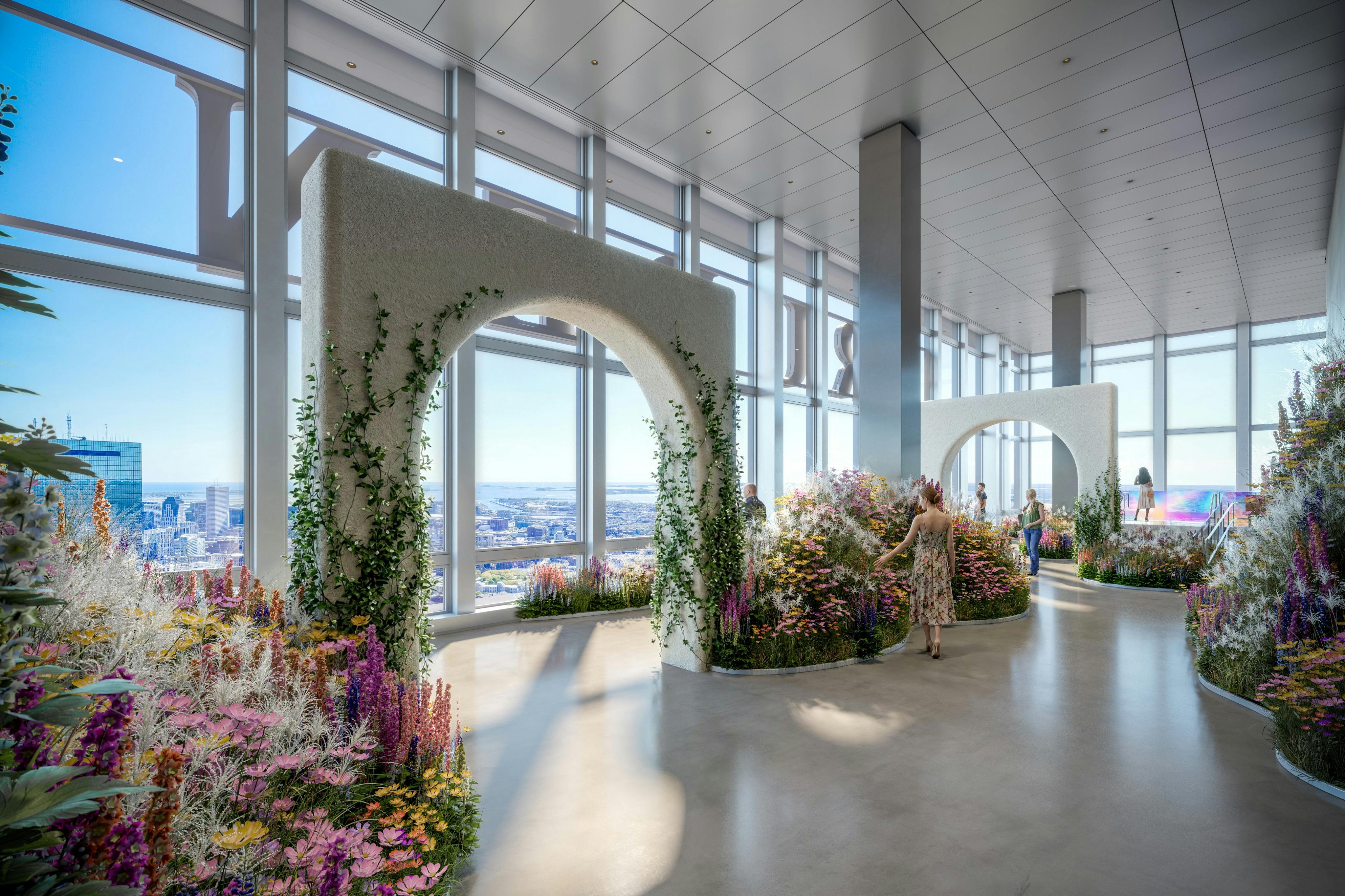 Un espace intérieur moderne avec de grandes fenêtres, des arrangements floraux et des structures arquées, avec quelques personnes qui marchent.