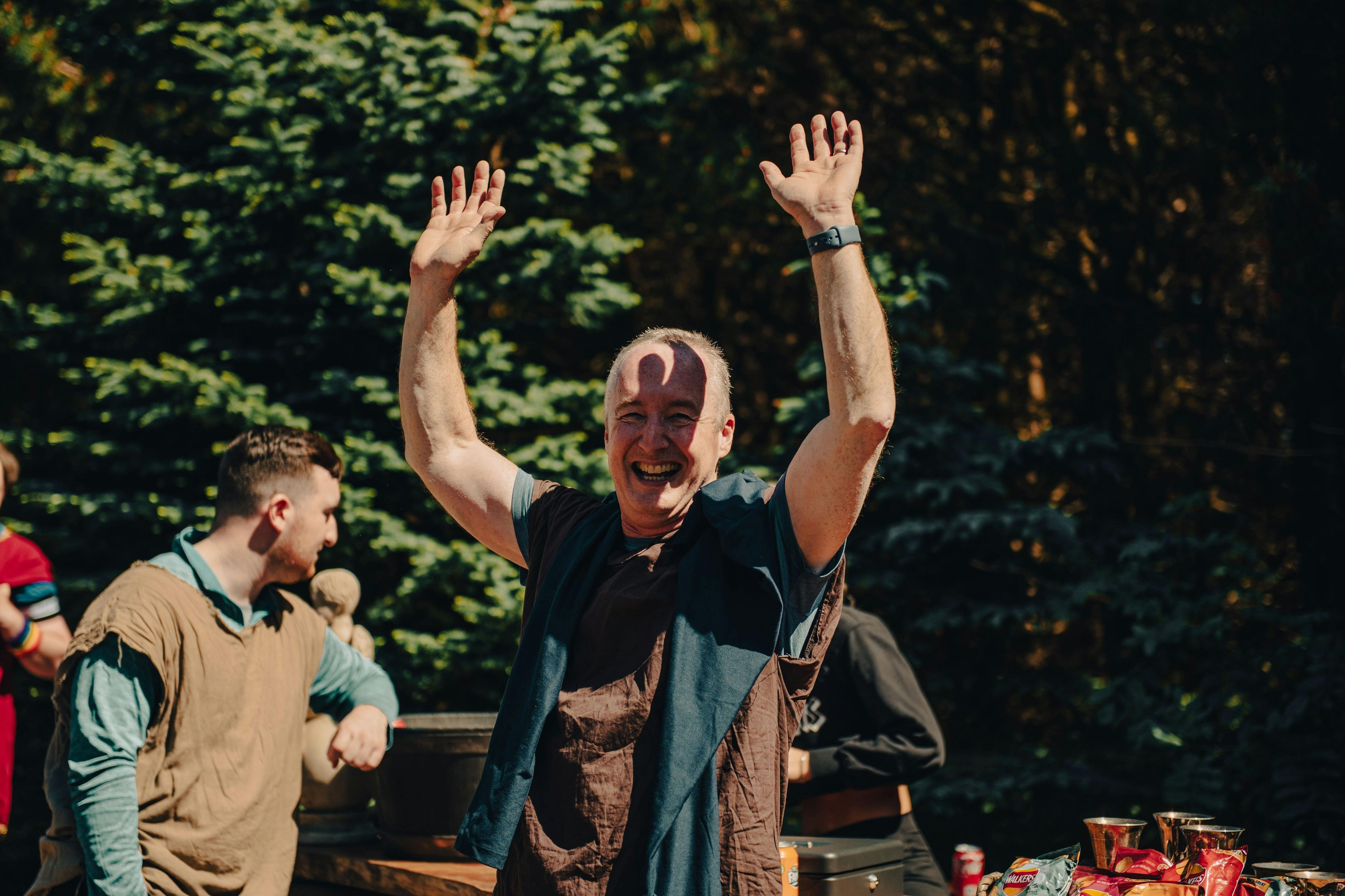 A victorious gladiator revels in his triumph, draped in the traditional garb of the Roman pleb