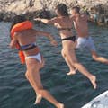 Jumping into the Egadi sea from a boat, embodying a moment of freedom.