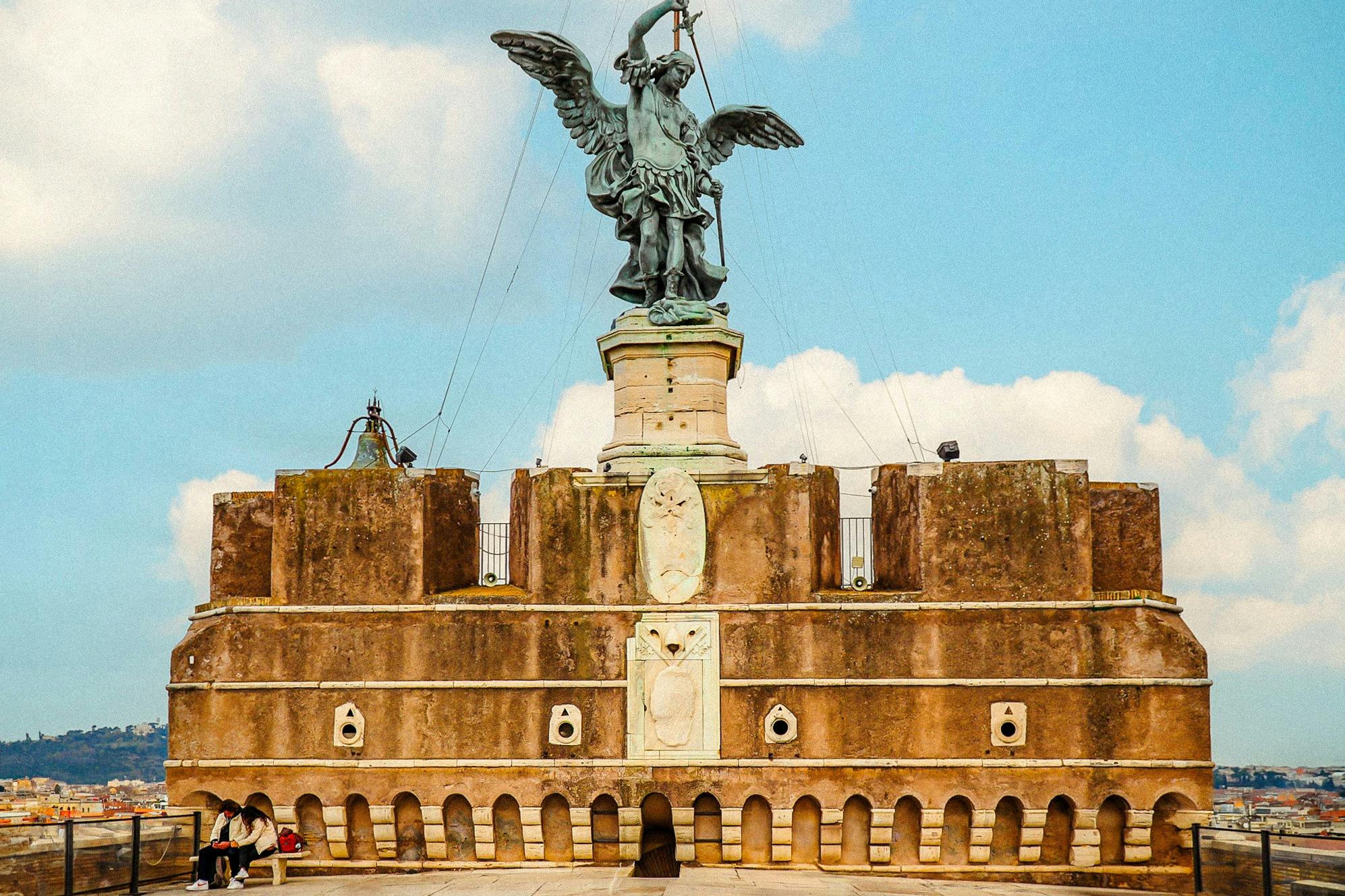 A picture of Michael's sculpture on top of Castel Sant'Angelo's building