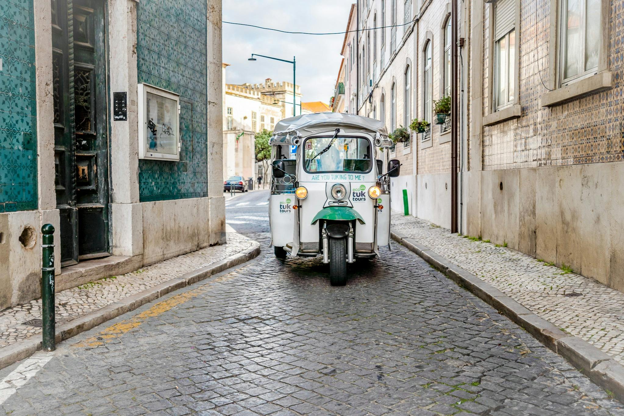 Tourists on a tuk tuk guided tour in Lisbon