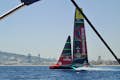 An America's Cup sailboat is training on the water in the Mediterranean.