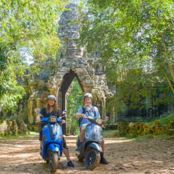 Enjoy the scenic ride on a vintage Vespa through Angkor Park with our driver.
