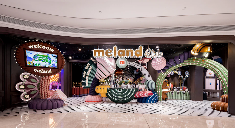 Entrance of the Meland Club, featuring colorful and whimsical decor with signage and playful designs.