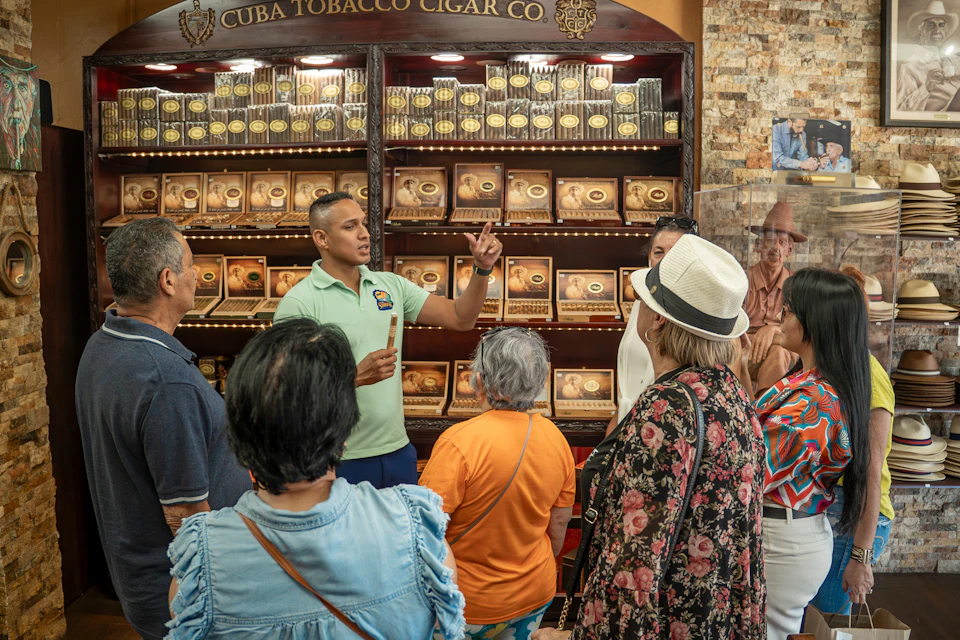 This image captures the fascinating process of crafting authentic Cuban cigars at a local cigar factory in Little Havana